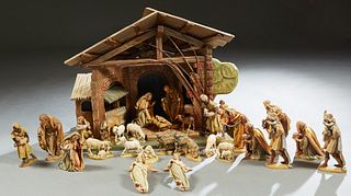 Thirty Piece Carved Wood Anri Nativity Set, 20th c., consisting of a large lighted manger with a windup music box, 2 Virgin Mary figures, 2 Joseph Fig