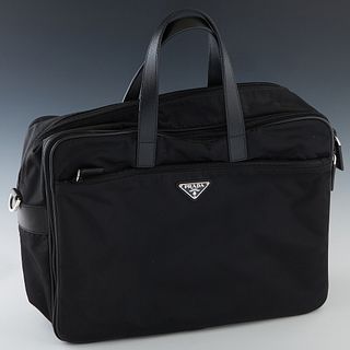 Prada Laptop Carrier, in black nylon and leather with black metal and silver hardware, the main computer compartment opening to a black Prada logo lin