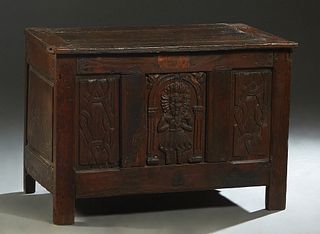 French Provincial Louis XIII Style Carved Oak Coffer, 19th c., the rectangular top over a three paneled front with a central relief figural carving fl