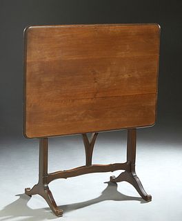 French Louis XVI Style Carved Walnut Folding Table, early 20th c., the rounded edge and corner rectangular top supported by a pivoting Y-form base, on