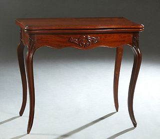 French Louis XV Style Carved Mahogany Games Table, early 20th c., the serpentine stepped rounded corner top, inset with a gilt tooled red baize playin