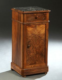 French Louis Philippe Carved Elm Marble Top Nightstand, 19th c., the inset highly figured canted corner black marble over a frieze drawer and a lower 