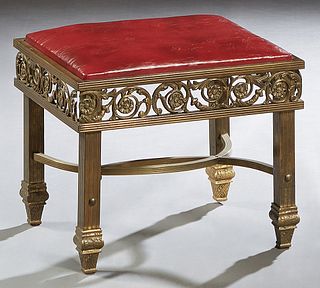 French Aesthetic Brass Bench, c. 1880, with a leather covered slip seat over a pierced relief floral decorated skirt, on square reeded legs, joined by