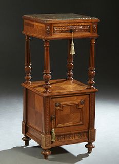French Carved Walnut Marble Top Nightstand, late 19th c., the inset highly figured brown marble over a frieze drawer, on turned tapered reeded support