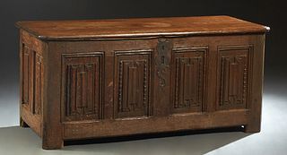 French Provincial Louis XIII Style Oak Coffer, 19th c., the canted corner rounded edge top over a front and sides with carved linenfold panels, on blo