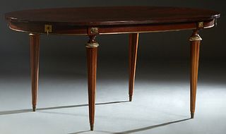 French Louis XVI Style Ormolu Mounted Carved Mahogany Dining Table, 20th c., the oval top over a wide skirt, on turned tapered ormolu mounted reeded l