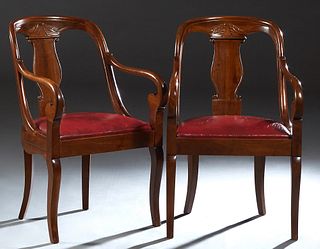 Pair of French Empire Style Barrel Back Armchairs, 20th c., the leaf carved curved back over a baluster vasiform splat, above a demilune red leather c