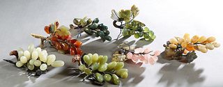 Group of Seven Carved Jade Grape Bunches, 20th c., four green, one pink, one beige and one brown, Largest- H.- 7 in., W.- 3 3/4 in., D.- 2 1/2 in. (7 