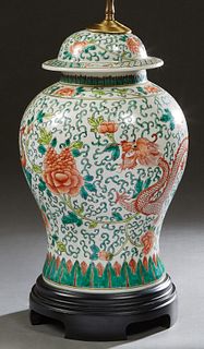 Chinese Famille Verte Covered Porcelain Ginger Jar, early 20th c., with colorful dragon, bird and floral decoration, now on a carved wooden base and w