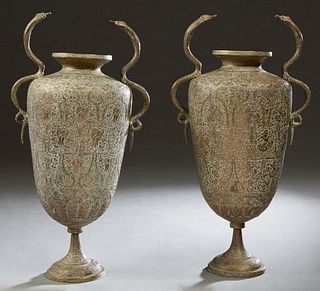 Pair of Indian Brass Baluster Urns, 20th c., with snake handles, with intricate incised decoration and cobra form handles, on a socle support to a ste