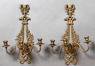Pair of Brass Three Light Sconces, early 20th c., with a pierced relief leaf and bow decorated back plate issuing three twisted scrolled candle arms, 