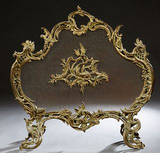 Louis XV Style Gilt Bronze Fireplace Screen, early 20th c., of cartouche form, with a pierced scrolled leaf frame, over a metal screen, with a center 