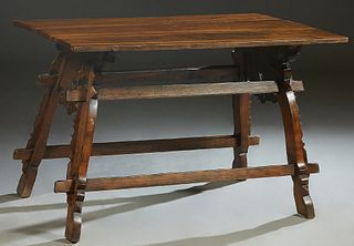 Continental Provincial Carved Oak Library Table, 19th c., the three board top on pierced trestle bases joined by a rectangular stretcher, H.- 30 in., 