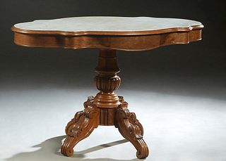 French Carved Walnut Marble Top Center Table, c. 1870, the inset figured white tortoise marble over a skirt with two side drawers, on a reeded urn for