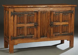 French Provincial Carved Oak Louis XVI Style Sideboard, 19th c., the rectangular top over double linenfold carved cupboard doors with iron strap hinge