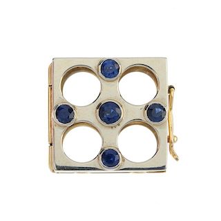 A sapphire pearl necklace enhancer. Of square-shape outline, set with circular-shape sapphires. Leng