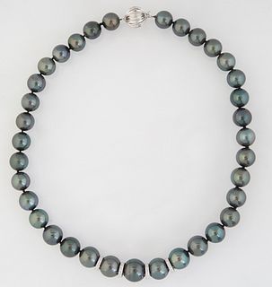 Strand of Thirty-Five Graduated Dark Gray Tahitian Cultured Pearls, ranging from 11-14mm, with a 14K white gold ball clasp, L.- 17 1/2 in. , with appr
