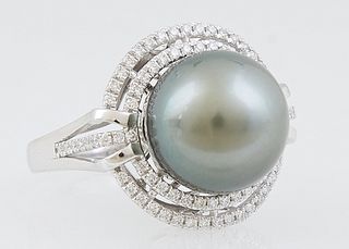 Lady's Platinum Dinner Ring, with a 14mm dark gray Tahitian cultured pearl, atop a pierced double graduated border of round diamonds, flanked by diamo