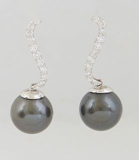 Pair of 14K White Gold Pendant Earrings, each with a swirled diamond mounted stud suspending a 13mm dark gray Tahitian cultured pearl, total diamond w