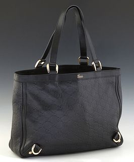 Gucci Abbey Tote Bag, in black calf leather with interlocking G's on the front and silver hardware, opening to a cream canvas lined interior with a zi