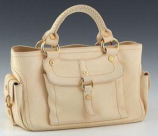 Celine Boogie Handbag, in light beige grained leather with gold accents, opening to a light brown canvas lined interior with a center zip pocket and t
