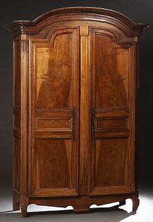 French Provincial Carved Walnut Louis XV Style Armoire, 19th c., the arched ogee crown over double arched three panel doors with long iron fiche hinge