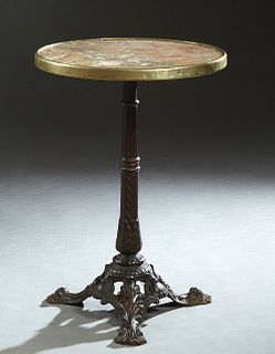 French Parisian Cast Iron Marble Top Bistro Table, late 19th c., the highly figured brass bound circular tan marble, on a turned and twisted iron supp