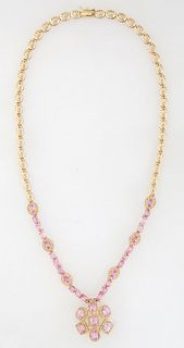 14K Yellow Gold Link Necklace, with forty pierced oval links, joined by three oval links on each side with oval pink sapphires, atop diamond mounted b