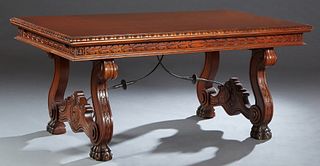 French Renaissance Style Drawleaf Dining Table, 20th c., the carved rounded edge top over a carved skirt, with two draw leaves, on large paw foot tres