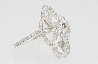 Lady's Platinum Dinner Ring, the pierced twisted top with an upper .32 ct. round diamond within a framework of tiny round diamonds, with diamond mount