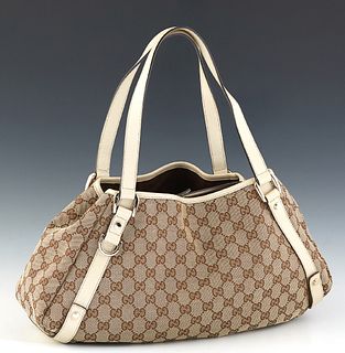 Gucci Abbey Hobo Diagonal Line, in beige monogrammed canvas with ivory leather accents and gold hardware, opening to a brown canvas lined interior wit