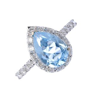 A diamond and topaz cluster ring. The pear-shape blue topaz, within a brilliant-cut diamond surround