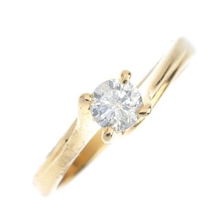 An 18ct gold diamond single-stone ring. The brilliant-cut diamond, to the spiral gallery and asymmet