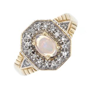 A 9ct gold opal and gem-set ring. The oval opal cabochon, within a colourless-gem surround and sides