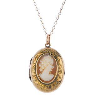A shell cameo locket and ring. The locket designed as an oval shell cameo, to the engraved surround,