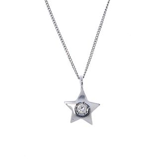 A diamond star pendant. The brilliant-cut diamond, within a star surround, suspended from an 18ct go