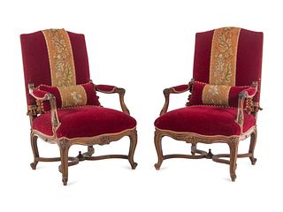 A Pair of Italian Louis XV Style Carved and Parcel Gilt Walnut Fauteuils