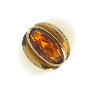 A citrine single-stone ring. The oval-shape citrine, to the tapered shoulders. Weight 8.1gms. <br><b