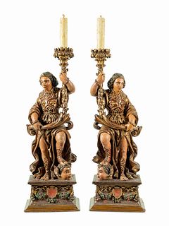 A Pair of Continental Carved, Painted and Parcel Gilt Figural Pricket Sticks