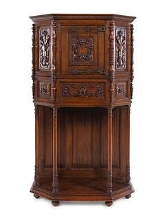 A Gothic Revival Carved Oak Cabinet on Stand