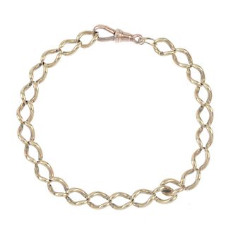 A 9ct gold curb-link bracelet. Designed as a series of elongated curb-links, to the replacement 9ct