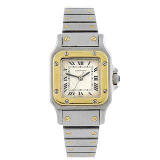 CARTIER - a Santos bracelet watch. Stainless steel case with yellow metal bezel. Numbered 090240654.