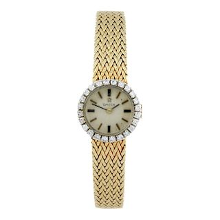 OMEGA - a lady's bracelet watch. Yellow metal case with factory diamond set bezel, stamped 14k. Numb