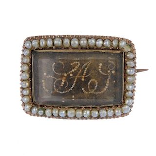 An early 19th century split pearl and hair memorial brooch. The woven hair panel with seed pearl mon
