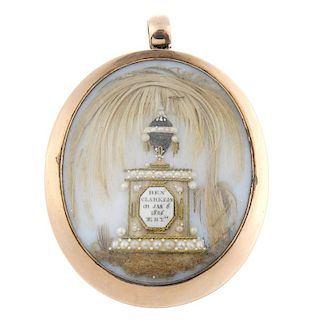 A George III gold memorial pendant. Of oval-shape outline, the opalescent glass panel with applied h