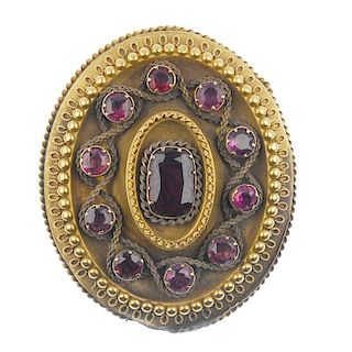 A mid 19th century garnet brooch. Of oval outline, the cushion-shape foil-back garnet, to the circul