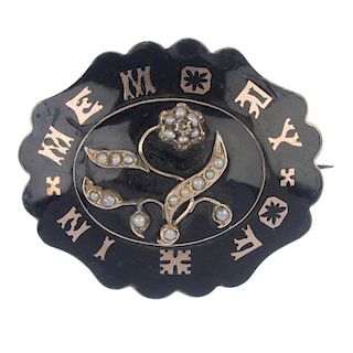 A mid Victorian enamel memorial brooch, circa 1870. The split pearl forget-me-not, atop a black enam