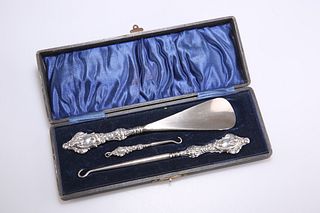 A GEORGE V SILVER-HANDLED BUTTON, GLOVE AND SHOE SET, by Ad