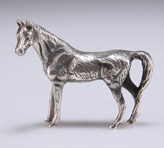 A CAST SILVER MODEL OF A HORSE, stamped 925. 5.2cm long, 1.