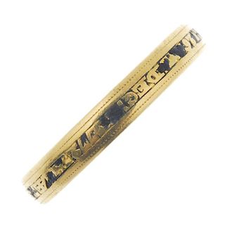 A late 19th century gold enamel memorial band ring. The central black enamel band, with raised inscr